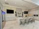 Modern clubhouse kitchen with marble countertops, stainless steel appliances, and bar seating at 4915 Kiva Cir, Bradenton, FL 34211