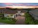 Beautiful front exterior of home with meticulously landscaped front yard and brick driveway with a view of the water at 4915 Kiva Cir, Bradenton, FL 34211