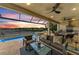Luxury screened-in patio with outdoor kitchen, living, dining, and pool overlooking the lake at 4915 Kiva Cir, Bradenton, FL 34211