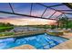 Beautiful pool and spa with a serene lake view at sunset at 4915 Kiva Cir, Bradenton, FL 34211