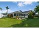 Backyard with well-manicured lawn, a patio, and a screened in porch at 5206 19Th W Ave, Bradenton, FL 34209
