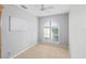 A bedroom with neutral walls and tiled floors features a large window and ceiling fan at 5206 19Th W Ave, Bradenton, FL 34209