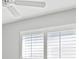 This bedroom has white walls and ceiling, shutters on the windows, and a white ceiling fan at 5206 19Th W Ave, Bradenton, FL 34209