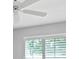This bedroom has white walls and ceiling, shutters on the windows, and a white ceiling fan at 5206 19Th W Ave, Bradenton, FL 34209