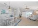 Open-concept dining room with tile floors, stylish chandelier, and sliding barn door at 5206 19Th W Ave, Bradenton, FL 34209