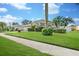 Charming single-Gathering home with a well-manicured lawn, mature palm trees, and lush landscaping at 5206 19Th W Ave, Bradenton, FL 34209