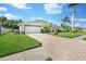 Charming single-Gathering home featuring a driveway, large garage, well-manicured lawn, and attractive landscaping at 5206 19Th W Ave, Bradenton, FL 34209