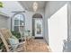 Inviting front porch with seating, brick flooring, and a decorative glass front door at 5206 19Th W Ave, Bradenton, FL 34209