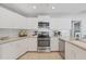Clean, functional kitchen with white cabinets, stone counters, and stainless appliances at 5206 19Th W Ave, Bradenton, FL 34209