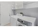 Well-equipped laundry room with white washer, dryer, and ample shelving for storage at 5206 19Th W Ave, Bradenton, FL 34209