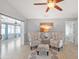 Cozy sitting area with two chairs and ottoman, light tile flooring, and a ceiling fan at 5206 19Th W Ave, Bradenton, FL 34209