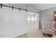 White sliding barn door opens to a sunroom at 5206 19Th W Ave, Bradenton, FL 34209