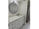 Stylish bathroom with white vanity, quartz countertop, decorative mirror, and tiled shower at 544 Mount Vernon Dr, Venice, FL 34293