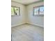 Cozy bedroom with tiled floors and two windows offering plenty of natural light at 544 Mount Vernon Dr, Venice, FL 34293
