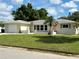 Charming single-story home featuring a manicured lawn, pink front door and a one-car garage at 544 Mount Vernon Dr, Venice, FL 34293