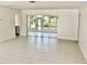 Spacious open-concept living area with light tile flooring and sliding glass doors to the lanai at 544 Mount Vernon Dr, Venice, FL 34293