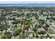 This aerial view captures the property's location within a neighborhood, featuring a nearby pool and coastal scenery at 5702 Tangerine S Ave, Gulfport, FL 33707