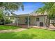 Charming home with covered patio, lush landscaping, and gravel path in backyard at 5702 Tangerine S Ave, Gulfport, FL 33707
