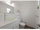 Powder room with decorative glass bowl sink and white cabinets at 5702 Tangerine S Ave, Gulfport, FL 33707