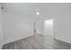 Bedroom features sleek gray flooring, ceiling fan, and an adjoining closet with shelving at 5702 Tangerine S Ave, Gulfport, FL 33707