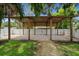 Covered carport area with white fence, providing ample parking space and privacy at 5702 Tangerine S Ave, Gulfport, FL 33707