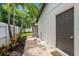 Paver path leading to side exterior door with landscaping and privacy fence at 5702 Tangerine S Ave, Gulfport, FL 33707