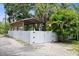 Exterior view of the fenced backyard, carport and surrounding landscape at 5702 Tangerine S Ave, Gulfport, FL 33707