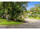 Charming home with a brick driveway, lush tropical landscaping, and a mailbox displaying the address at 5702 Tangerine S Ave, Gulfport, FL 33707