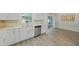 Bright kitchen with backyard view, features stainless appliances, and open flow to dining area at 5702 Tangerine S Ave, Gulfport, FL 33707