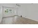Well-lit living room with hardwood floors and a large window offering ample natural light at 5702 Tangerine S Ave, Gulfport, FL 33707