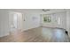 Open-concept living room boasts modern wood floors and plenty of natural light from the entry and hallway at 5702 Tangerine S Ave, Gulfport, FL 33707