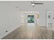 Open living space with hardwood floors and sliding glass doors leading to the backyard at 5702 Tangerine S Ave, Gulfport, FL 33707
