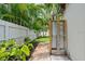 Outdoor shower area with paver path, plants and white fence for added privacy at 5702 Tangerine S Ave, Gulfport, FL 33707
