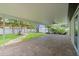 Large, covered patio overlooking a well-maintained yard with tropical landscaping elements at 5702 Tangerine S Ave, Gulfport, FL 33707