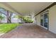 Spacious covered patio with brick pavers and lush landscaping, perfect for entertaining at 5702 Tangerine S Ave, Gulfport, FL 33707
