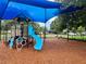 Bright blue playground equipment under a blue shade canopy, offering safe play on a wood chip surface at 5702 Tangerine S Ave, Gulfport, FL 33707