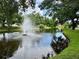 Picturesque pond with a fountain and lush green surroundings, framed by trees in a serene park setting at 5702 Tangerine S Ave, Gulfport, FL 33707