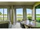 Back porch seating area with peaceful views of the golf course providing a relaxing outdoor space at 5916 Wake Forest Run # 101, Bradenton, FL 34211