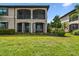 Beautiful two story condo with screened in back porch and balcony overlooking lush landscaping and tropical palm trees at 5916 Wake Forest Run # 101, Bradenton, FL 34211