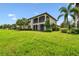 Beautiful two story condo with screened in back porch and balcony overlooking lush landscaping and tropical palm trees at 5916 Wake Forest Run # 101, Bradenton, FL 34211