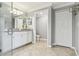Bathroom with large glass shower, neutral gray walls, white cabinets and tile floors at 5916 Wake Forest Run # 101, Bradenton, FL 34211
