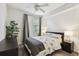 Cozy bedroom with hardwood floors, neutral walls, fan, and a view to the outside at 5916 Wake Forest Run # 101, Bradenton, FL 34211