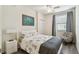 Cozy bedroom with hardwood floors, neutral walls, fan, and a view to the outside at 5916 Wake Forest Run # 101, Bradenton, FL 34211
