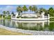 Stone 'Lakewood National' sign surrounded by a pond and palm trees creates a welcoming entrance to the community at 5916 Wake Forest Run # 101, Bradenton, FL 34211
