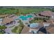 Overhead image of a community pool featuring bridges, a sandy area, lounge chairs, cabanas, landscaping and the clubhouse at 5916 Wake Forest Run # 101, Bradenton, FL 34211