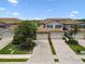 Gorgeous aerial view of the home showcasing the attached garage, manicured lawn, and lush landscaping at 5916 Wake Forest Run # 101, Bradenton, FL 34211