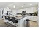 Bright kitchen featuring a large island, stainless steel appliances, and granite countertops at 5916 Wake Forest Run # 101, Bradenton, FL 34211