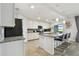 Bright kitchen featuring a large island, stainless steel appliances, and granite countertops at 5916 Wake Forest Run # 101, Bradenton, FL 34211