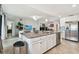 Bright kitchen featuring a large island, stainless steel appliances, and granite countertops at 5916 Wake Forest Run # 101, Bradenton, FL 34211