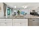 Bright kitchen featuring a large island, stainless steel appliances, and granite countertops at 5916 Wake Forest Run # 101, Bradenton, FL 34211